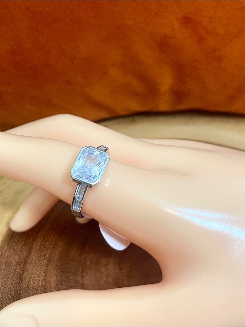 Rhodium Plated Emerald Cut Bezel Set East to West Cubic Zirconia Ring
